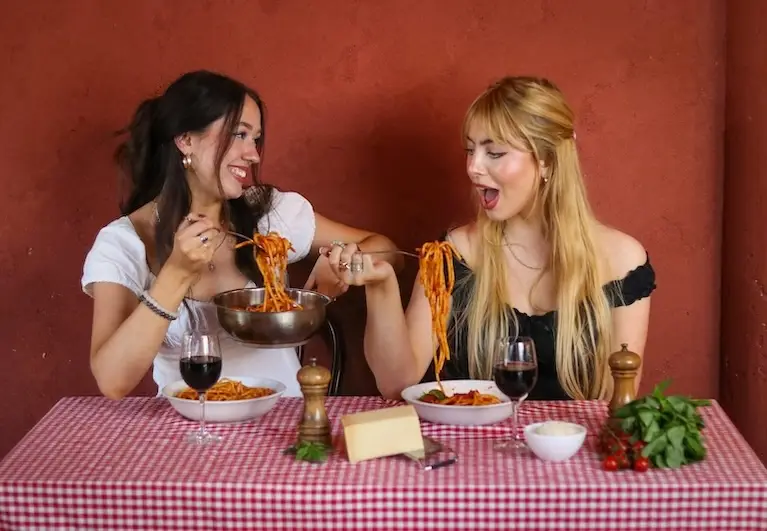 Young people enjoying eating pasta 3 mobile